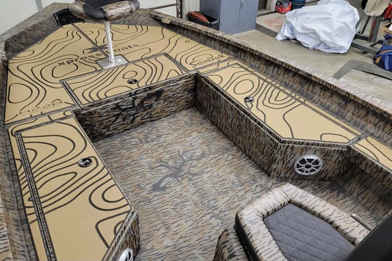 Slide: The Image of 2026 Xpress H22B Bay boat interior with custom camo design and seating. - 3