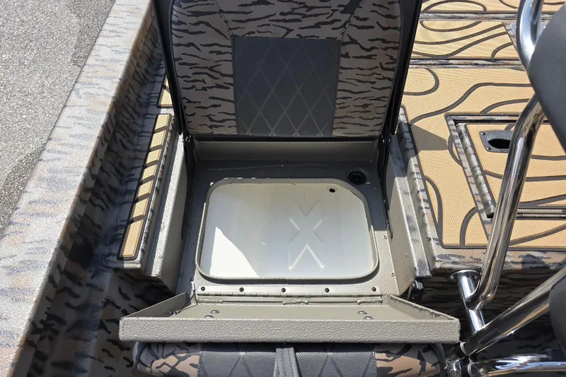 Slide: The Image of 2026 Xpress H22B Bay boat interior with open storage compartment and patterned seating. - 31