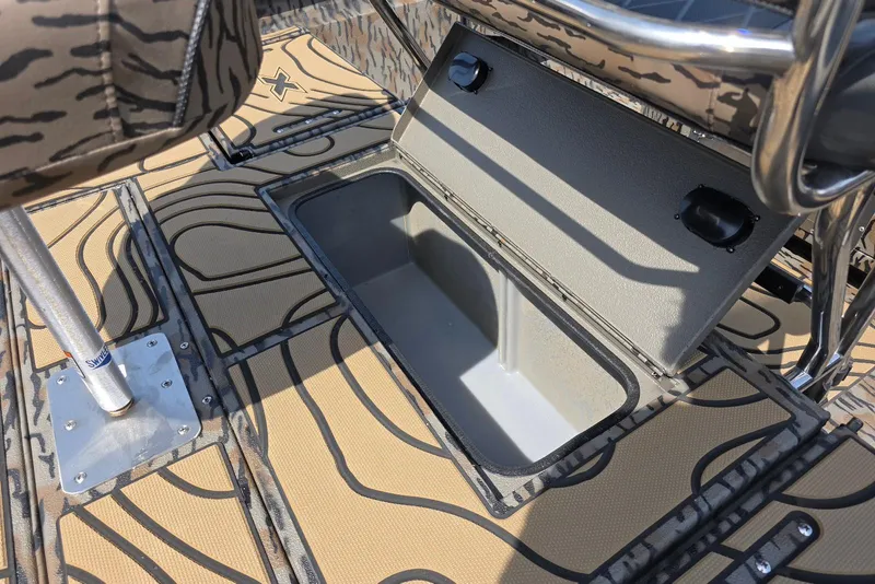 Slide: The Image of 2026 Xpress H22B Bay boat with open storage compartment and patterned flooring. - 32