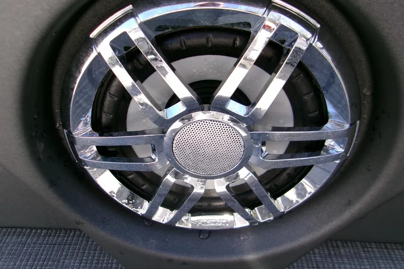 Slide: The Image of Close-up of a chrome speaker grille on a 2025 Avalon 2585 Quad Lounger. - 11
