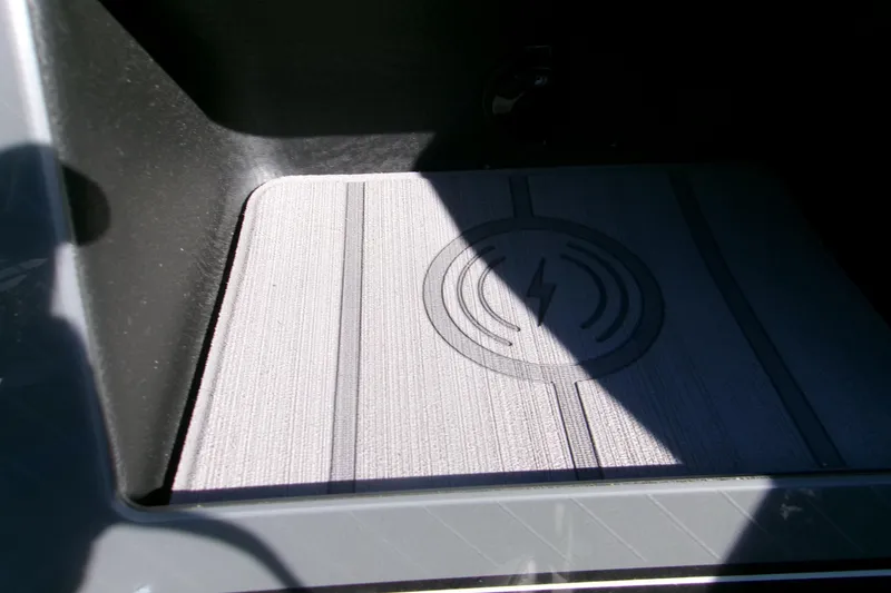 Slide: The Image of 2025 Avalon 2585 Quad Lounger wireless charging pad in shadowed compartment. - 14