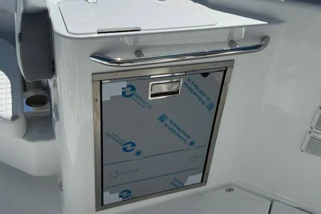 Slide: The Image of 2026 Wellcraft 38 T-Top boat interior with stainless steel storage compartment. - 11