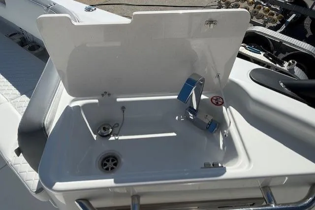 Slide: The Image of 2026 Wellcraft 38 T-Top boat sink with faucet and storage compartment. - 15