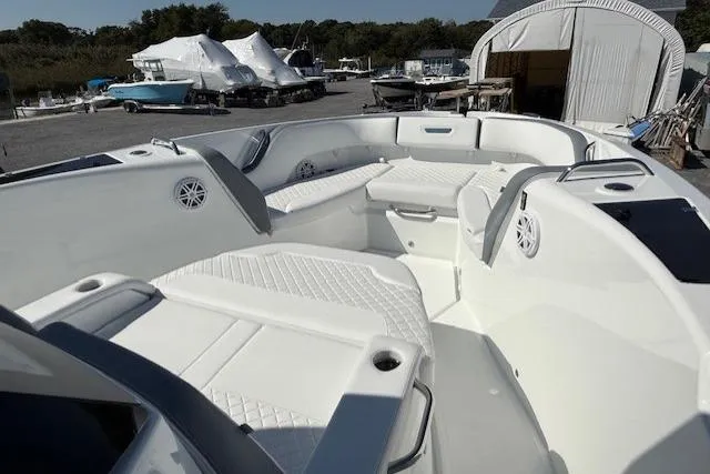 Slide: The Image of 2026 Wellcraft 38 T-Top boat with spacious seating and modern design in a marina setting. - 21