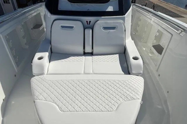 Slide: The Image of 2026 Wellcraft 38 T-Top boat interior with white cushioned seating and cup holders. - 22