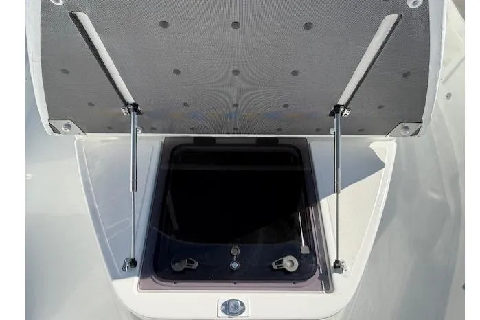Slide: The Image of 2026 Wellcraft 38 T-Top boat hatch open, showcasing storage compartment. - 23