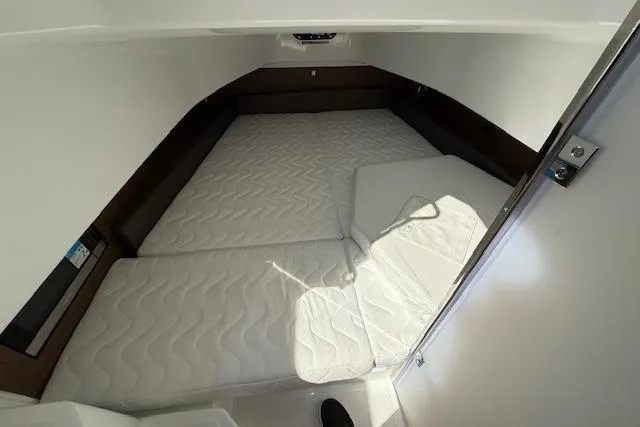 Slide: The Image of 2026 Wellcraft 38 T-Top cabin interior with white mattress and modern design. - 29
