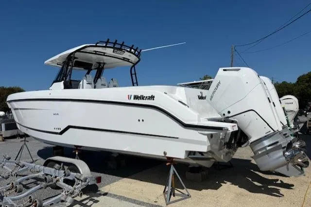 Slide: The Image of 2026 Wellcraft 38 T-Top boat with dual engines on display outdoors. - 3