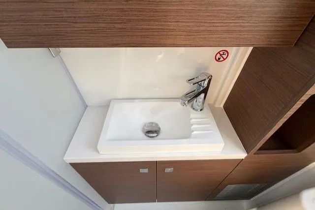 Slide: The Image of Modern bathroom sink in 2026 Wellcraft 38 T-Top boat, featuring sleek design and wood accents. - 32