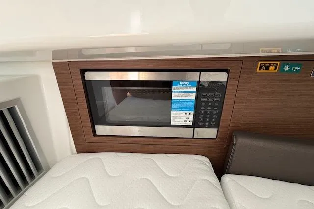 Slide: The Image of Microwave in 2026 Wellcraft 38 T-Top boat interior, featuring modern design and wood paneling. - 33