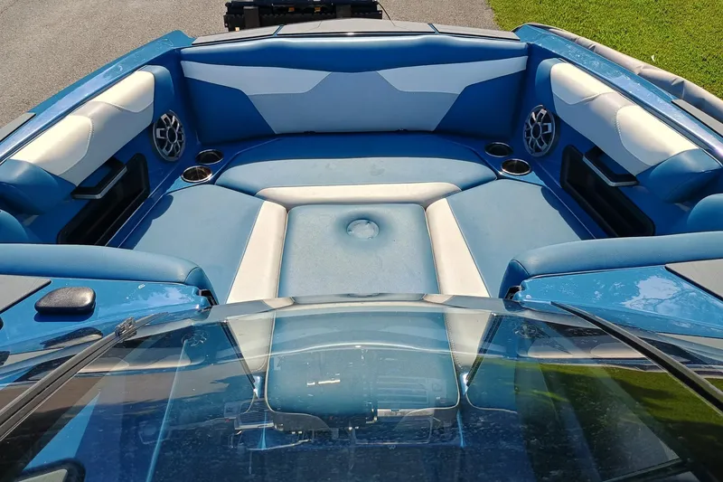 Slide: The Image of Interior of 2022 Axis A22 boat with blue and white seating. - 2