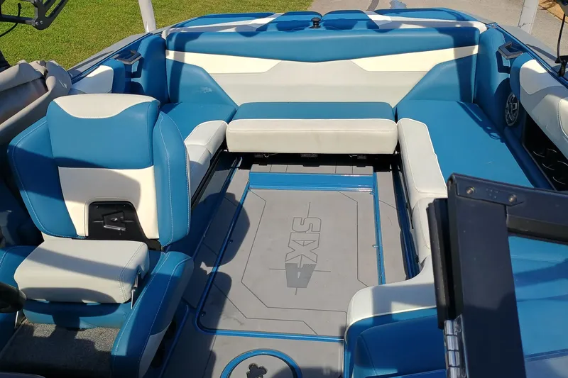 Slide: The Image of 2022 Axis A22 boat interior with blue and white seating, showcasing spacious design. - 3