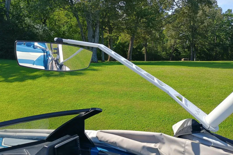 Slide: The Image of 2022 Axis A22 boat mirror with green lawn and trees in the background. - 6