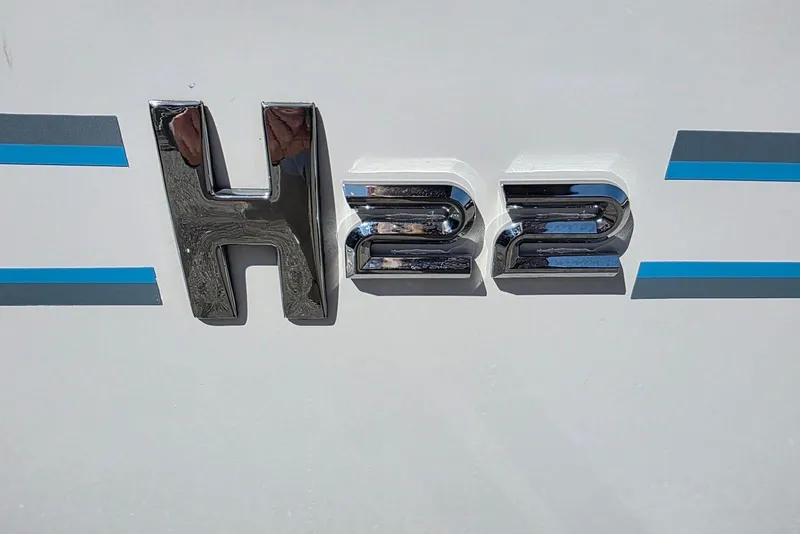 Slide: The Image of 2026 Xpress H22B Bay boat emblem with blue and gray stripes. - 11