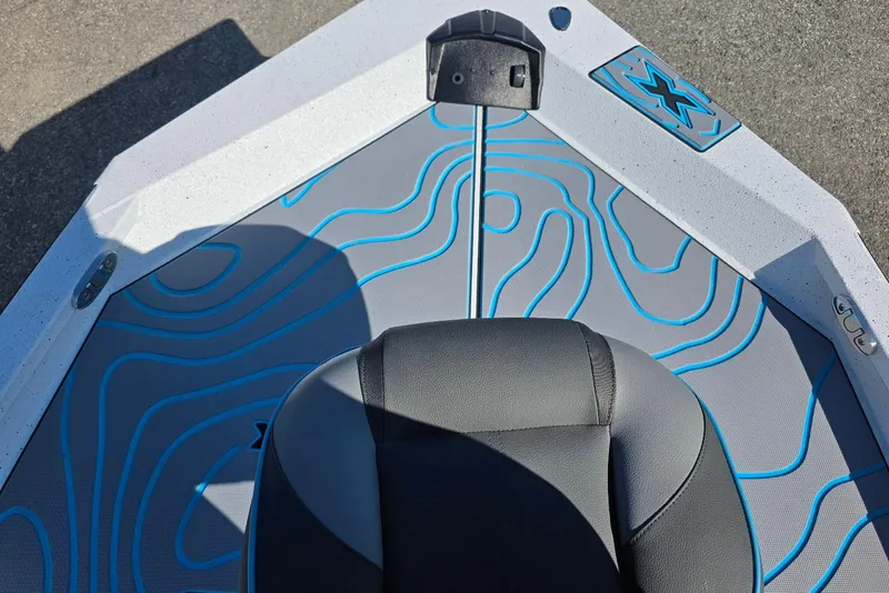 Slide: The Image of 2026 Xpress H22B Bay boat interior with blue contour design and black seat. - 15