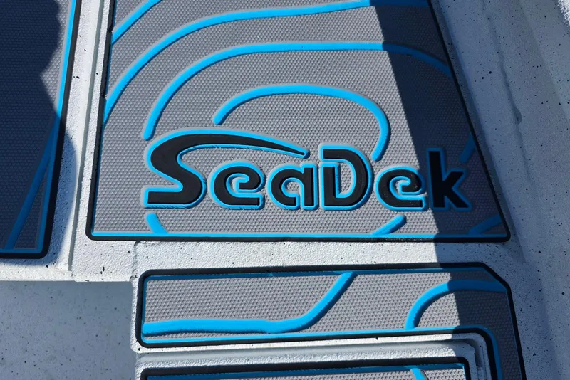 Slide: The Image of SeaDek flooring on 2026 Xpress H22B Bay boat, featuring blue and gray design. - 17