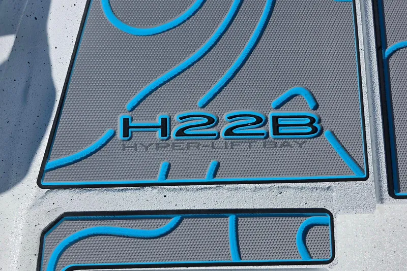 Slide: The Image of 2026 Xpress H22B Bay boat deck with blue accents and textured design. - 18