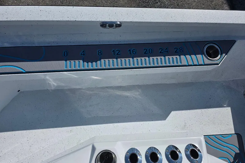 Slide: The Image of 2026 Xpress H22B Bay boat interior with measurement scale and rod holders. - 24