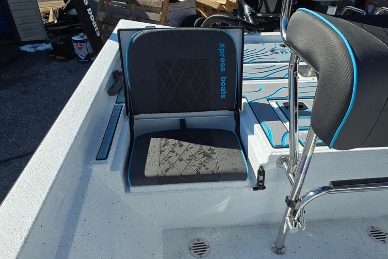 Slide: The Image of 2026 Xpress H22B Bay boat seat with blue accents and modern design. - 28