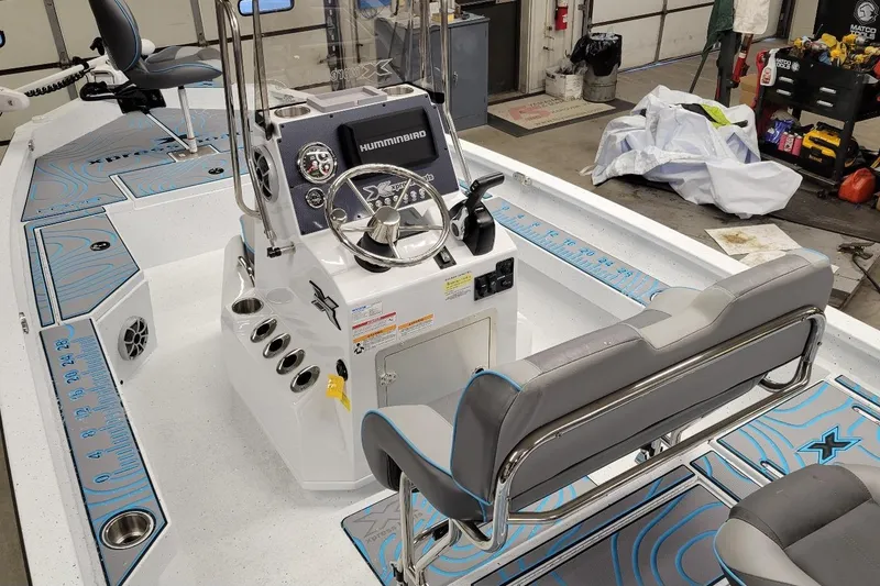 Slide: The Image of 2026 Xpress H22B Bay boat interior with steering console and seating. - 3