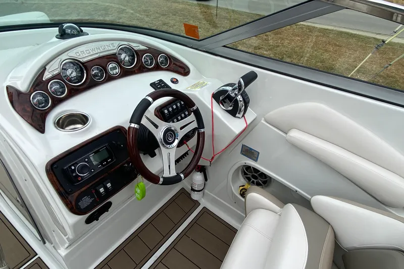 Slide: The Image of Cockpit of 2015 Crownline 305 SS boat with steering wheel and control panel. - 10