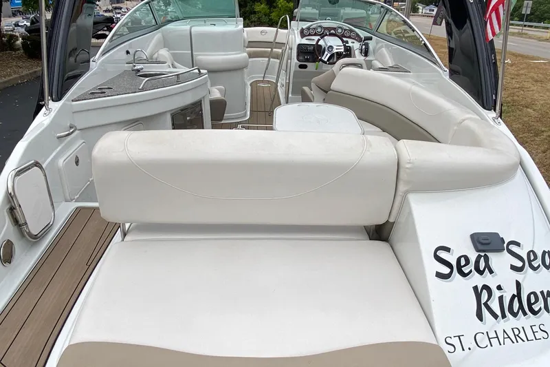 Slide: The Image of 2015 Crownline 305 SS boat interior with seating and helm, featuring modern amenities. - 6