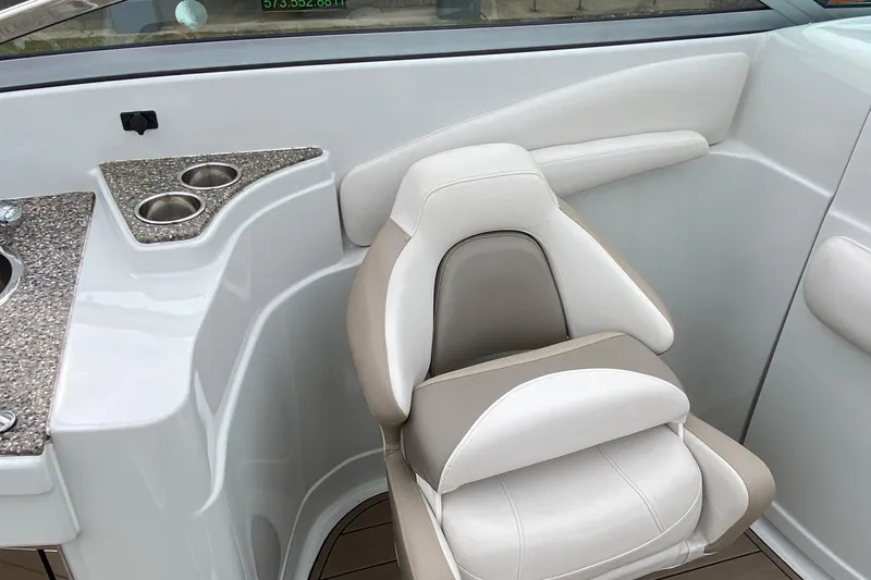 Slide: The Image of 2015 Crownline 305 SS boat interior with cushioned seat and cup holders. - 8
