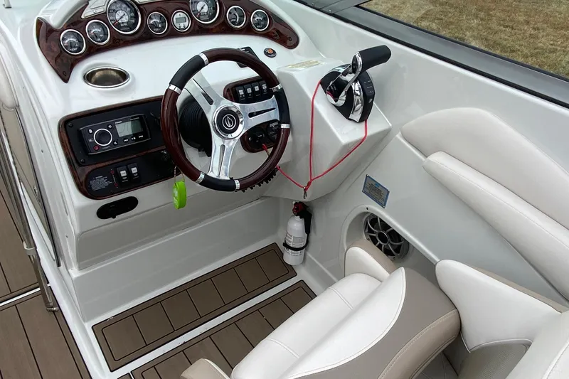 Slide: The Image of Steering console of 2015 Crownline 305 SS boat with modern controls and gauges. - 9