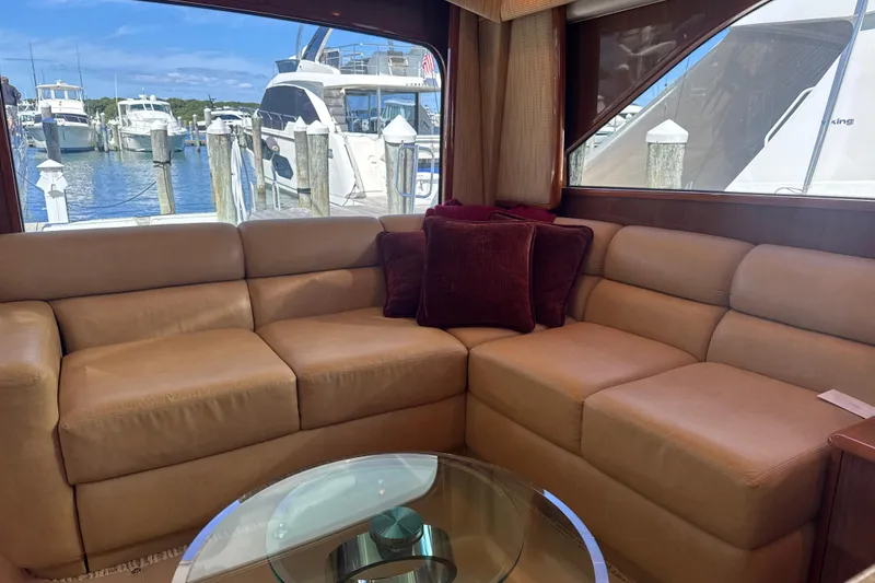 Slide: The Image of Luxurious interior of 2006 Viking 56 Convertible yacht with leather seating and marina view. - 11