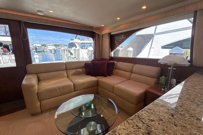 Slide: The Image of Luxurious interior of 2006 Viking 56 Convertible yacht with leather seating and marina view. - 14