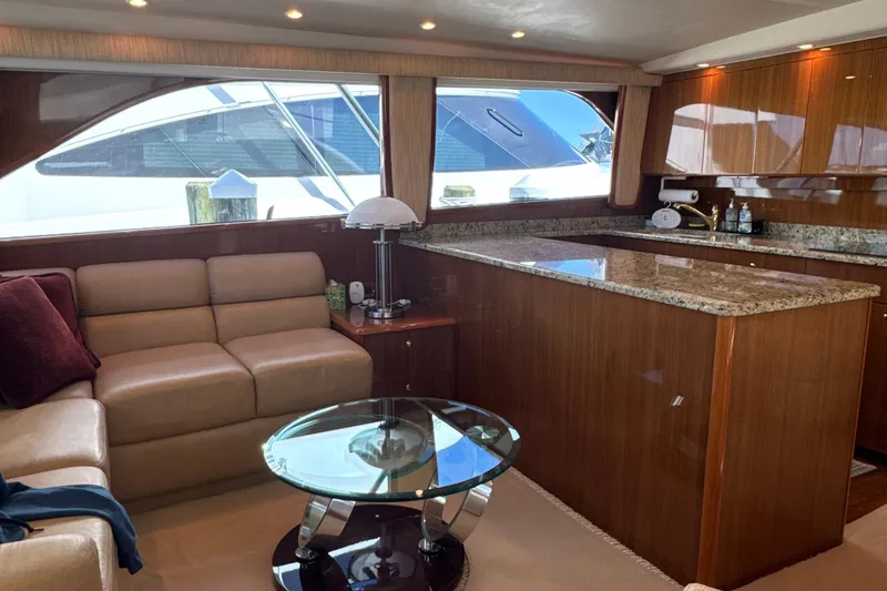 Slide: The Image of Luxurious interior of a 2006 Viking 56 Convertible yacht with leather seating and granite countertops. - 15