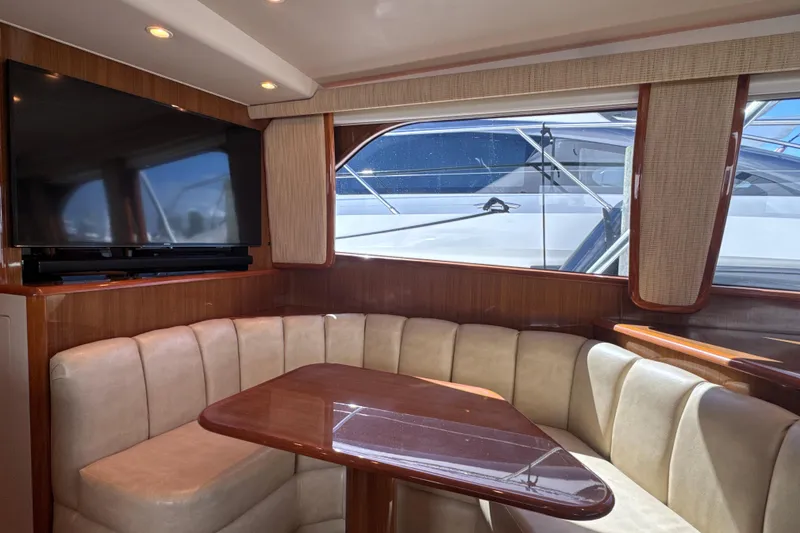 Slide: The Image of Luxurious interior of 2006 Viking 56 Convertible yacht with plush seating and large TV. - 16