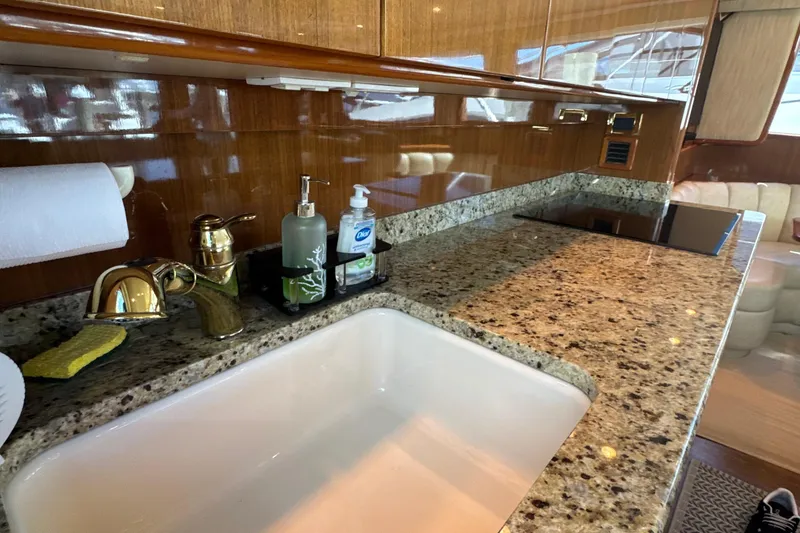 Slide: The Image of Luxurious kitchen area in a 2006 Viking 56 Convertible yacht with granite countertops. - 20