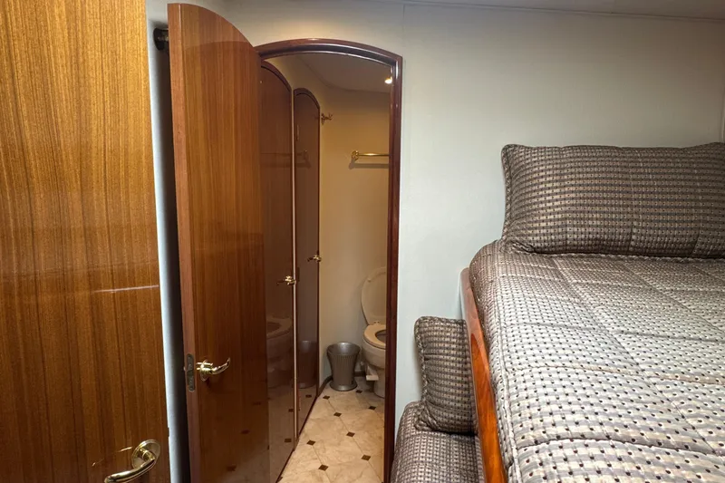 Slide: The Image of Interior of 2006 Viking 56 Convertible yacht with cozy bedroom and bathroom. - 27