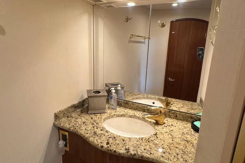 Slide: The Image of Luxurious bathroom in 2006 Viking 56 Convertible yacht with granite countertop and gold fixtures. - 28
