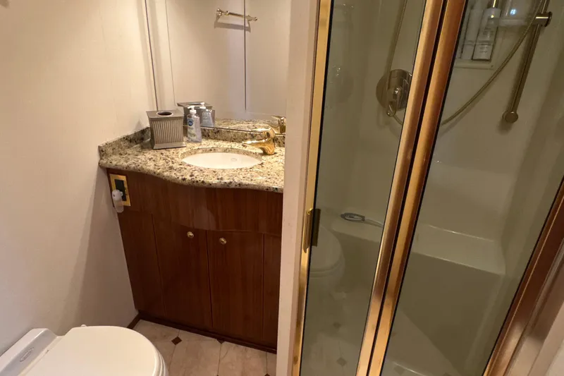 Slide: The Image of Luxurious bathroom in 2006 Viking 56 Convertible yacht with granite countertop and glass shower. - 29