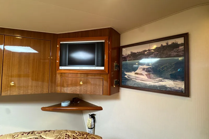 Slide: The Image of Interior of 2006 Viking 56 Convertible yacht with TV and framed boat picture. - 32