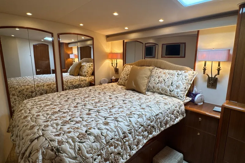 Slide: The Image of Luxurious bedroom interior of 2006 Viking 56 Convertible yacht with elegant bedding and warm lighting. - 34