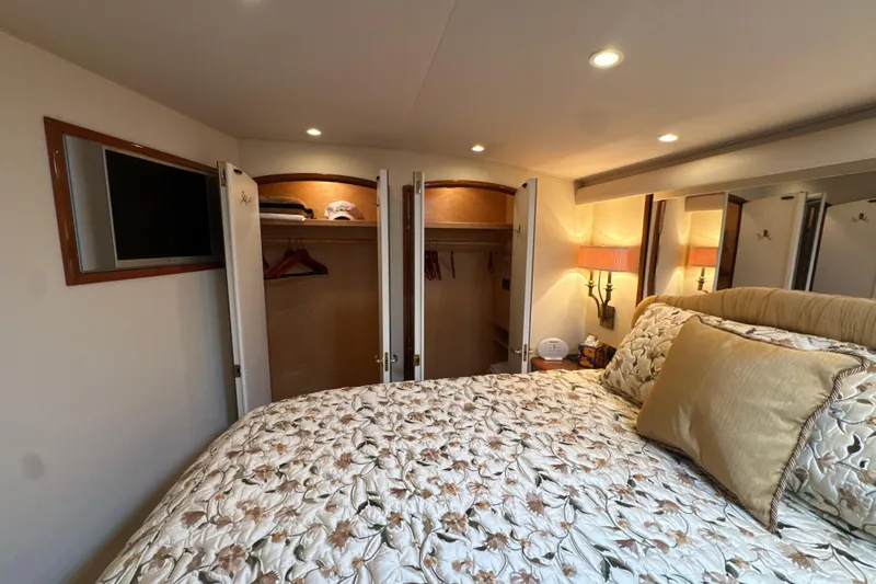 Slide: The Image of Luxurious bedroom interior of 2006 Viking 56 Convertible yacht with closet and TV. - 35