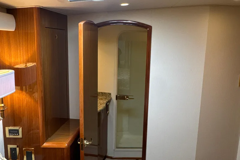 Slide: The Image of Interior of 2006 Viking 56 Convertible yacht with wooden cabinetry and open door. - 37