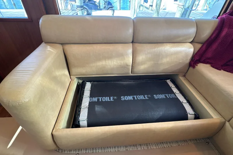 Slide: The Image of Beige sofa with hidden storage on a 2006 Viking 56 Convertible yacht. - 43