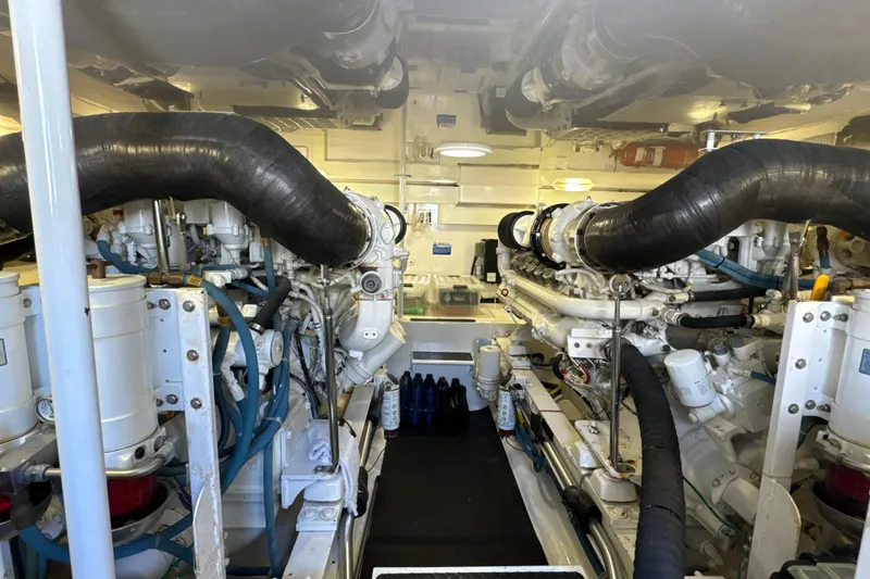 Slide: The Image of Engine room of a 2006 Viking 56 Convertible yacht, showcasing dual engines and mechanical components. - 44