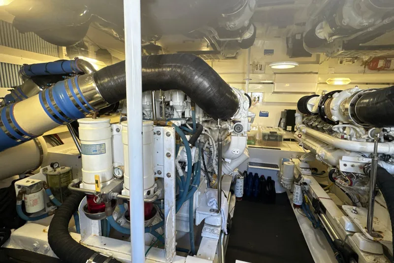 Slide: The Image of Engine room of a 2006 Viking 56 Convertible yacht, showcasing dual engines and mechanical components. - 45