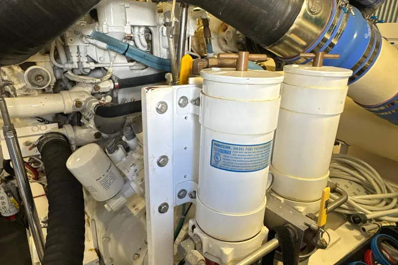 Slide: The Image of Engine room of a 2006 Viking 56 Convertible yacht, featuring diesel fuel filters. - 47