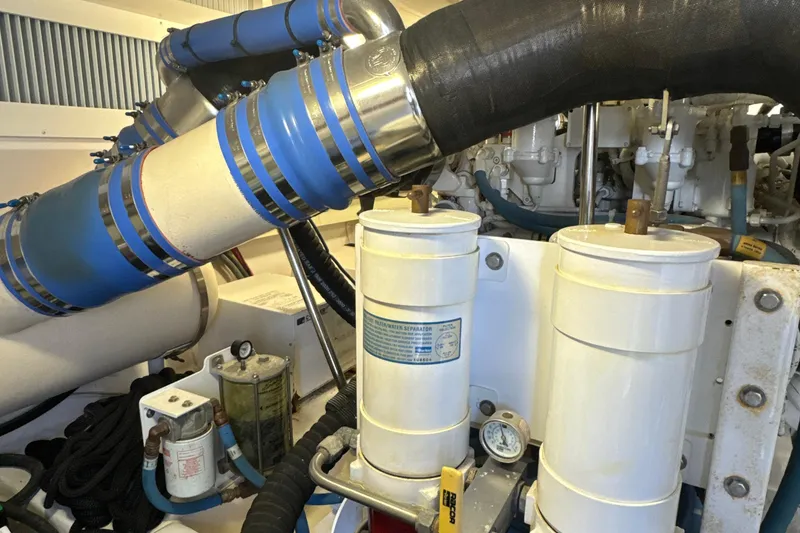 Slide: The Image of Engine room of 2006 Viking 56 Convertible yacht with visible filters and piping. - 48