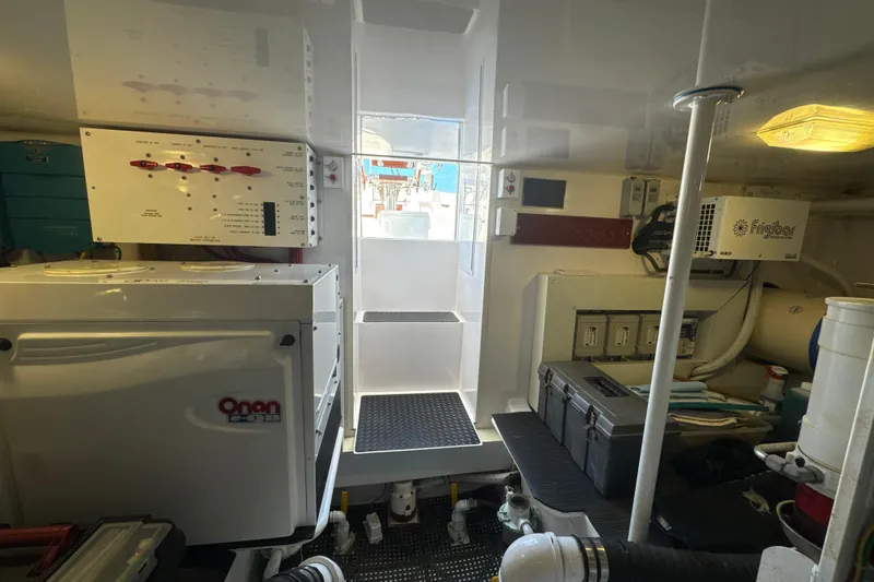 Slide: The Image of Engine room of a 2006 Viking 56 Convertible yacht, featuring Onan generator and Frigibar equipment. - 50