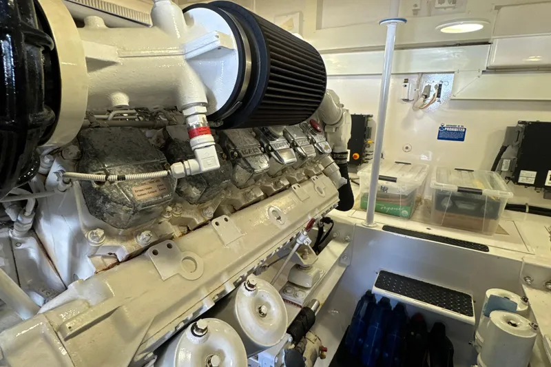 Slide: The Image of Engine room of a 2006 Viking 56 Convertible yacht, showcasing detailed machinery components. - 52