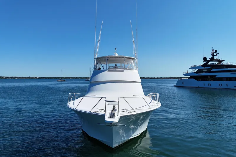 Slide: The Image of 2006 Viking 56 Convertible yacht on calm water, clear blue sky background. - 6