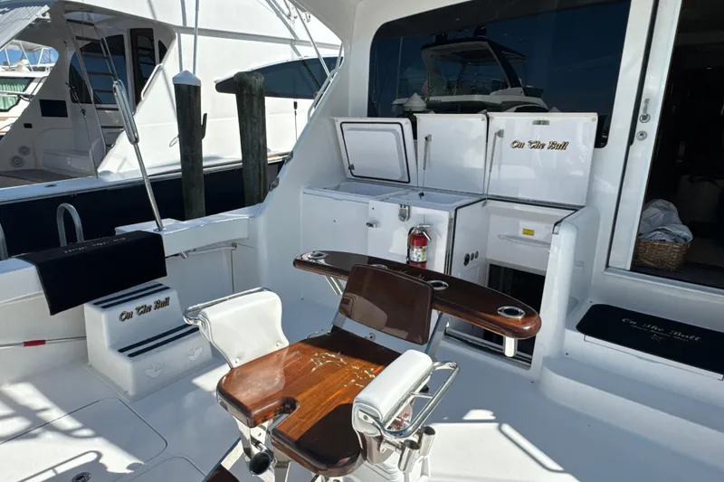 Slide: The Image of 2006 Viking 56 Convertible yacht cockpit with fishing chair and storage compartments. - 60