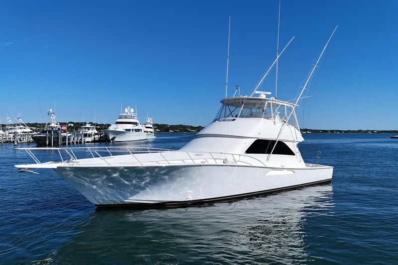 Slide: The Image of 2006 Viking 56 Convertible yacht on calm water under clear blue sky. - 7